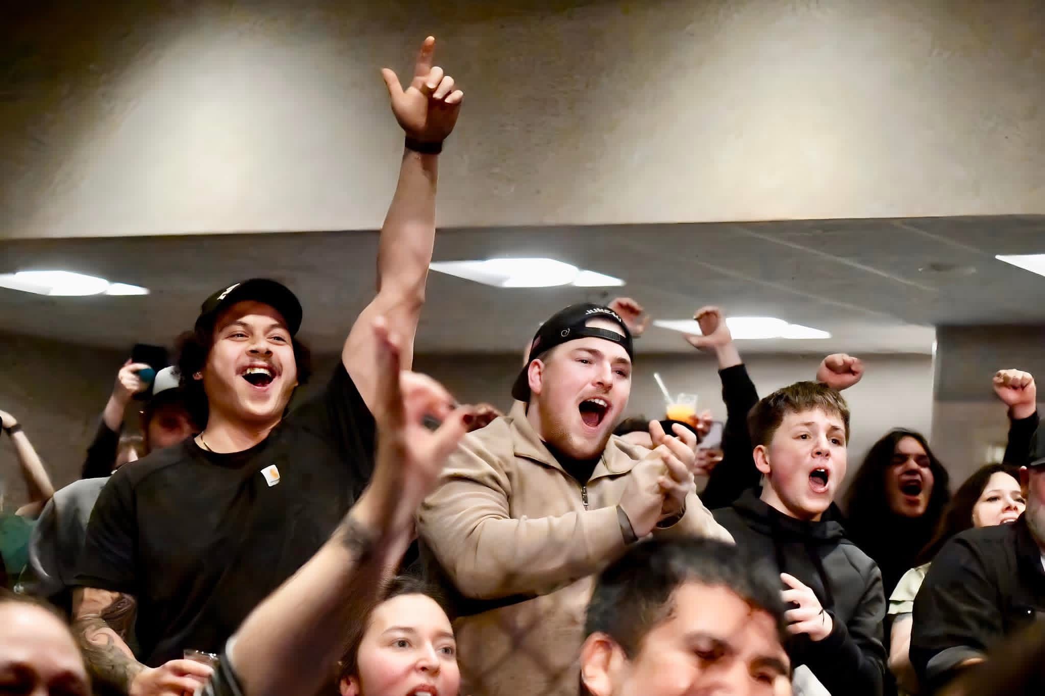 Audience with hands raised in excitement